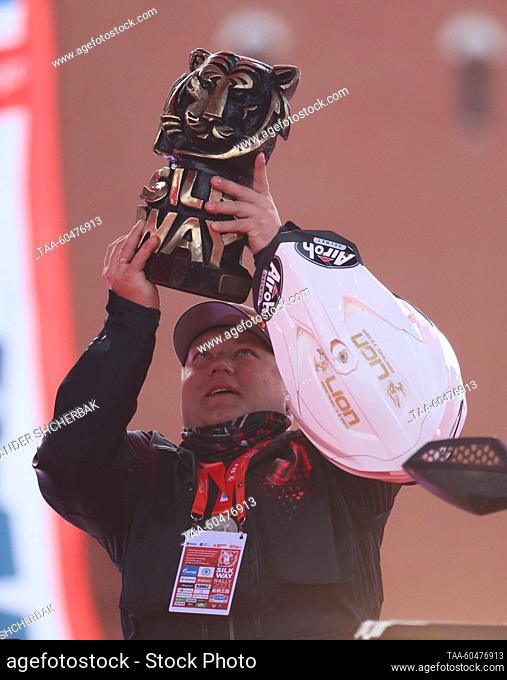 RUSSIA, MOSCOW - JULY 15, 2023: Rider Anatoly Kuznetsov raises his trophy as he wins the first Enduro Quad prize during a ceremony to finish the 2023 Silk Way...