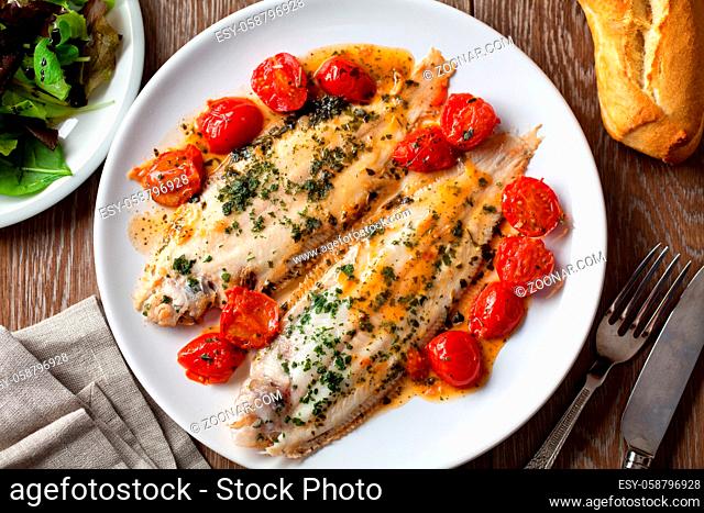 Sole with cherry tomatoes on a plate. High quality photo