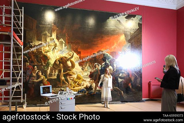 RUSSIA, ST PETERSBURG - DECEMBER 21, 2023: A woman poses for a photo by Karl Bryullov's history painting The Last Day of Pompeii at a press briefing on the...