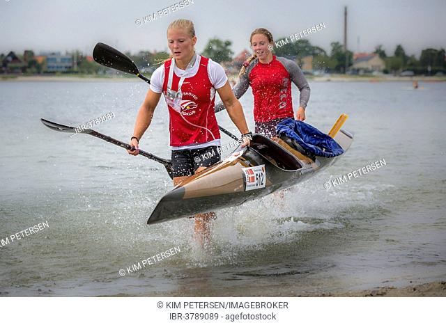 Two female kayakers carrying a kayak, Copenhagen Beach Marathon for Kayak and Canoe 2013, Copenhagen, Capital region, Denmark