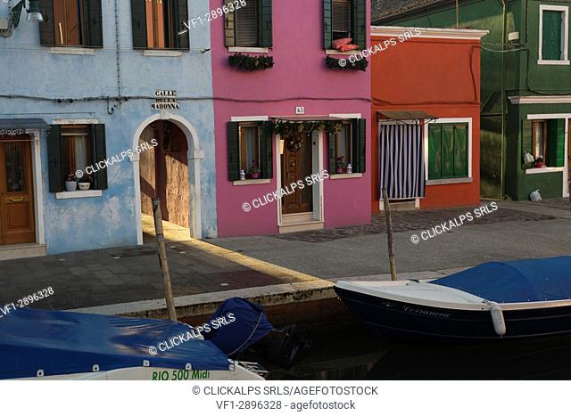 Europe, Italy, Veneto, Venice. Ray of sunshine among the colors of Burano