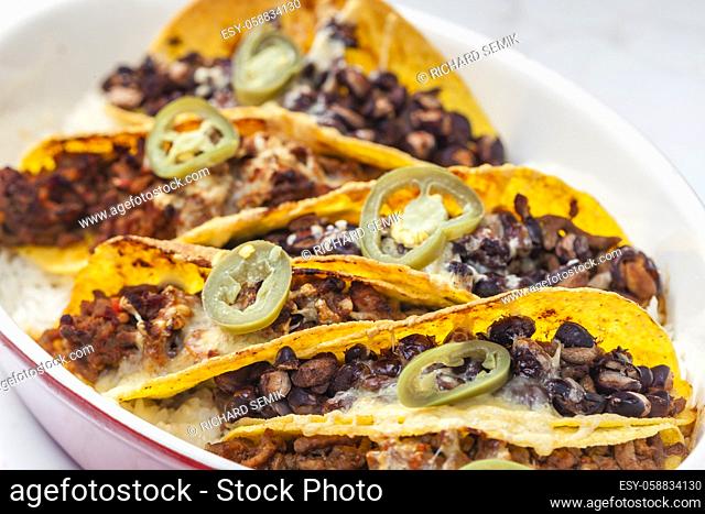 tacos filled with minced meat and black beans
