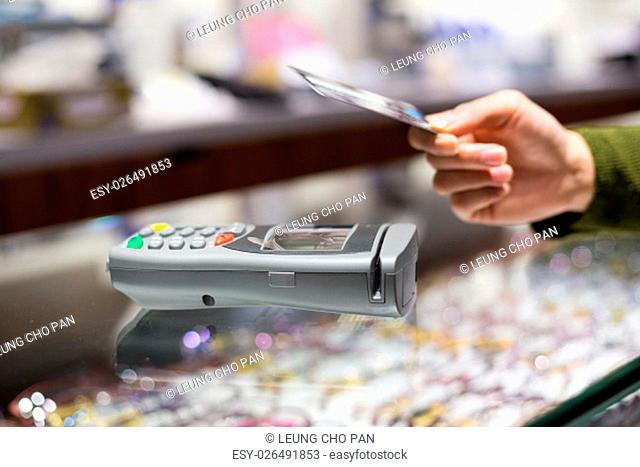 Woman pay with credit card by NFC