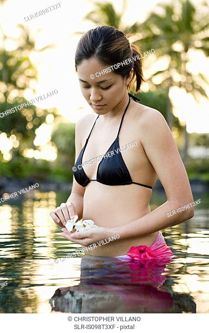 Woman in water with flowers