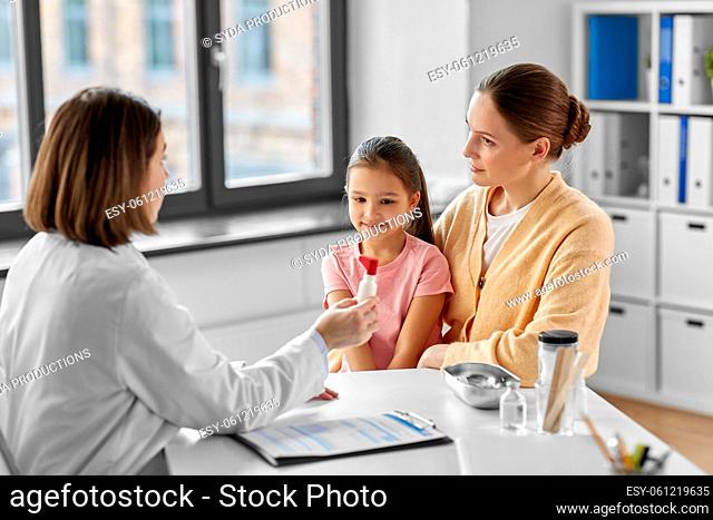 mother, child and doctor with medicine at clinic