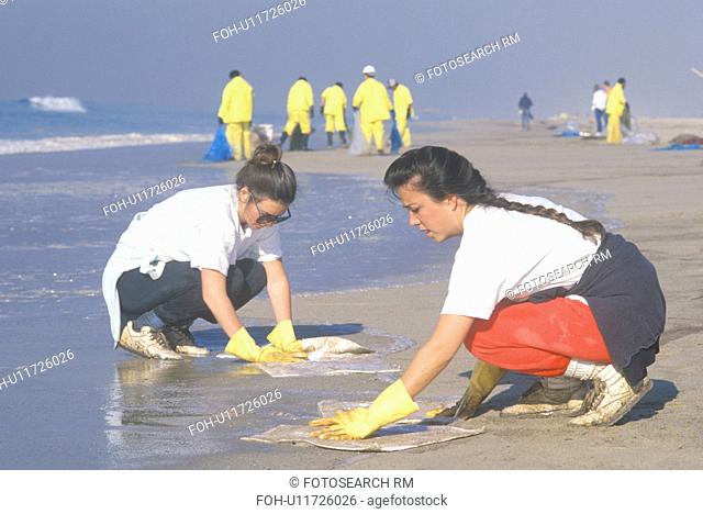 Two women participating in an environmental clean up