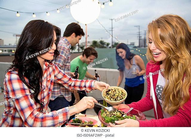 Young adult friends enjoying food at barbeque