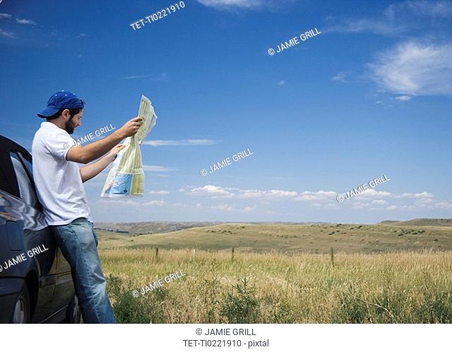 Man reading a map outdoors