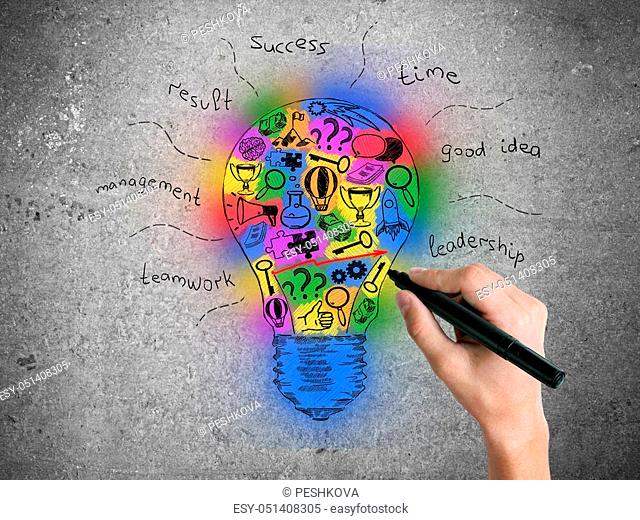 Hand drawing creative colorful lightbulb sketch on concrete wall. Idea concept