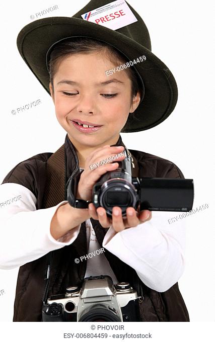 portrait of a little girl dressed as a photographer