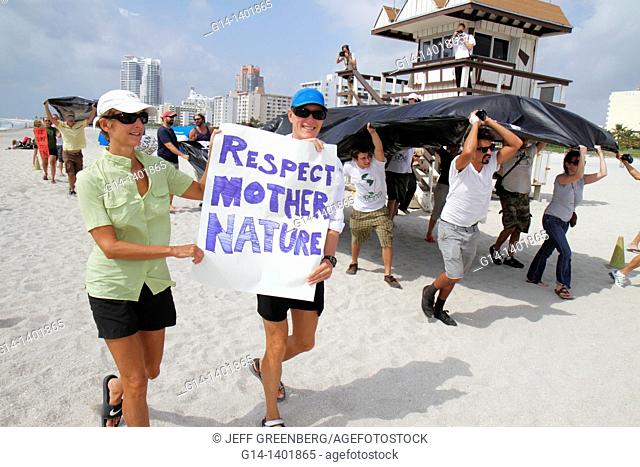 Florida, Miami Beach, oil spill protest, offshore drilling, black plastic sheet represents slick, Atlantic Ocean, sign, poster