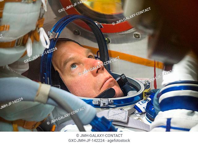 In his Soyuz TMA-19M spacecraft in the Integration Facility at the Baikonur Cosmodrome in Kazakhstan, Expedition 46-47 crewmember Tim Kopra of NASA runs through...