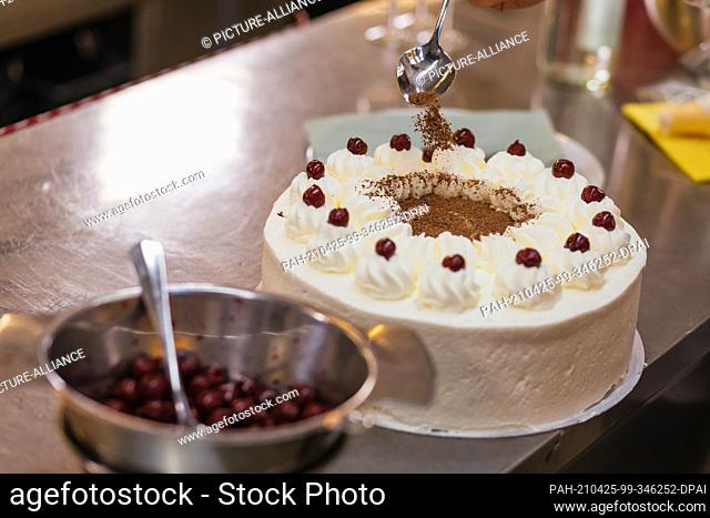 25 April 2021, Baden-Wuerttemberg, Todtnauberg: Alfred ""Freddy"" Boch, owner of the Hotel Engel, makes a Black Forest gateau ahead of a livestream of the Black...