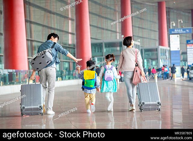 A happy family with luggage at the airport