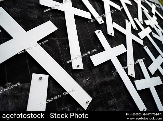 01 May 2020, North Rhine-Westphalia, Duisburg: Crosses are mounted on a wall at the memorial site for the victims of the Love Parade 2010