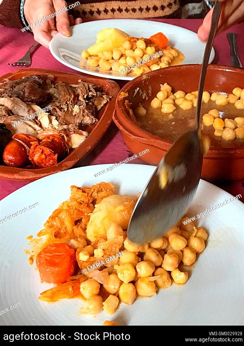 Serving cocido madrileño. Madrid, Spain