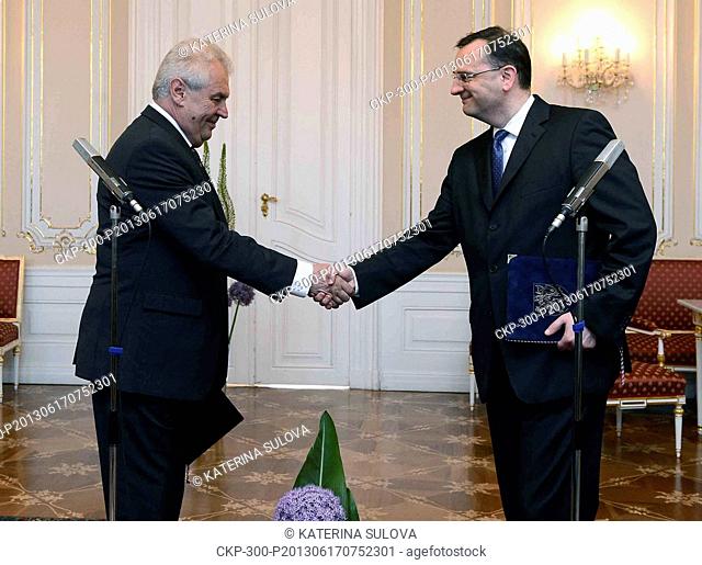 Czech Prime Minister Petr Necas (Civic Democratic Party, ODS), right, tenders his resignation to President Milos Zeman, left