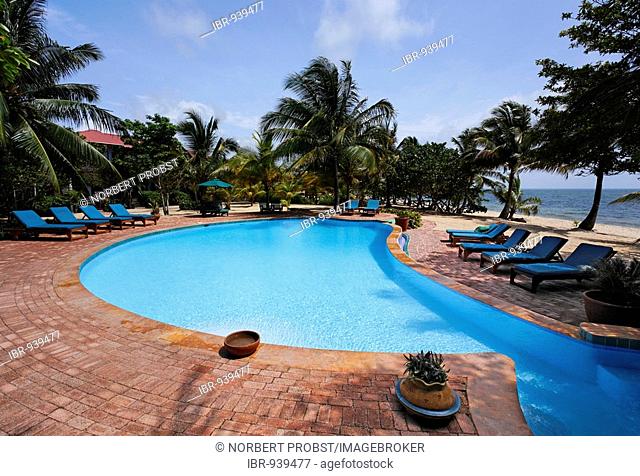 Deckchairs alongside a swimming pool, Hamanasi Hotel, Hopkins, Dangria, Belize, Central America, Caribbean