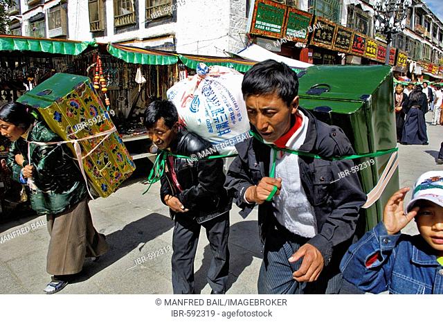 Tibetian with heavy load on the Barkor (walk around the Jokhang temple) , Nam-Tsho-Lake, Tibet