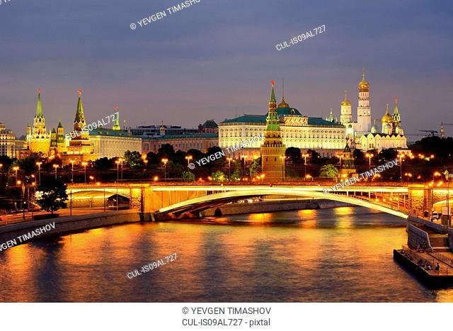 View of Kremlin towers and the Bolshoy Kamenny bridge over Moskva river at night, Moscow, Russia