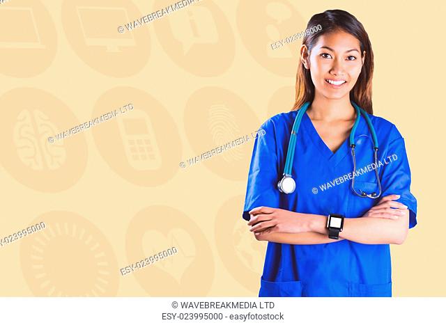 Asian nurse with stethoscope crossing arms against orange background