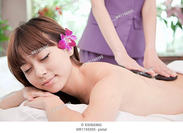 Woman Receiving Hot Stone Massage
