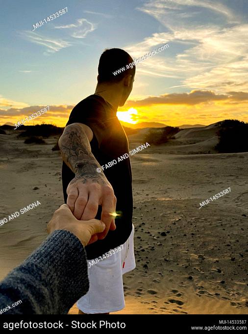 Pov of couple holding hands and enjoying together a great sunset time. Travel and holiday summer vacation people in love or friendship