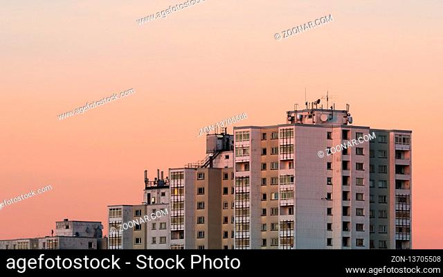 An apartment house at a sunset with clear orange sky. Berlin, February, 15-2019