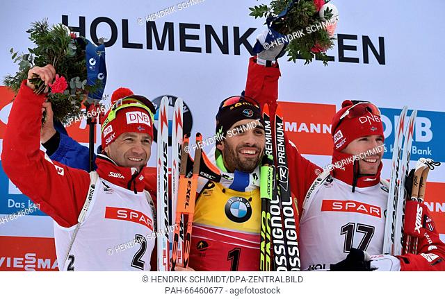 Gold medal winner Martin Fourcade of France (C) is flanked on the podium by silver medalist Ole Einar Bjoerndalen (L) of Norway and bronze medalist Emil Hegle...