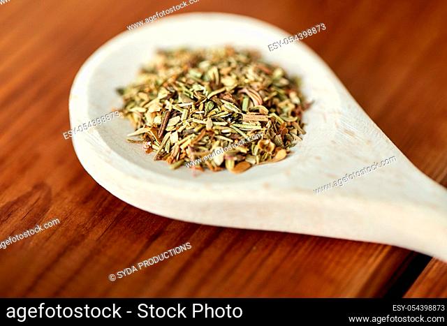 close up of dry spices on wooden spoon