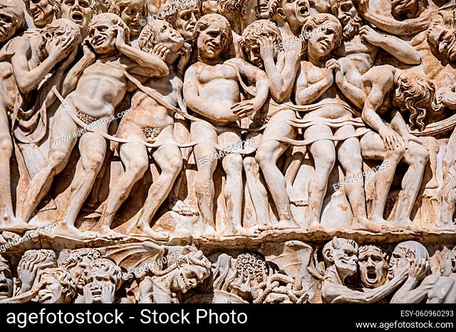Close-up of the opulent and elaborated embossed sculptures in the Orvieto Cathedral (Duomo) on a sunny day in Orvieto, a pleasant and well preserved medieval...