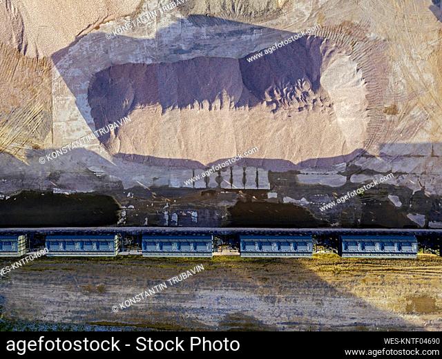 Russia, Tikhvin, Aerial view of railroad cars along sand pit in asphalt plant
