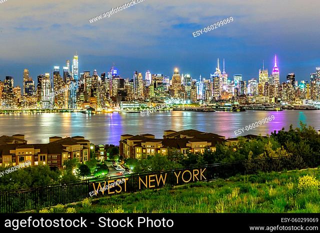 West New York City midtown Manhattan skyline panorama view from Boulevard East Old Glory Park over Hudson River at dusk