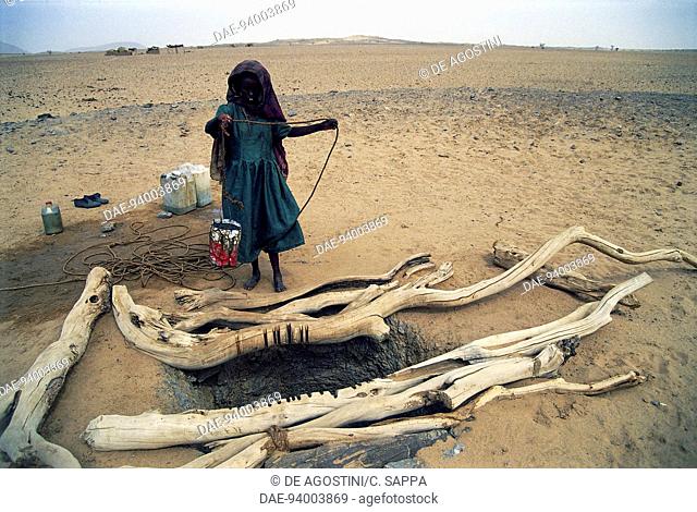 Woman drawing water from a well near Sani, Bayuda desert, Sahara desert, Sudan