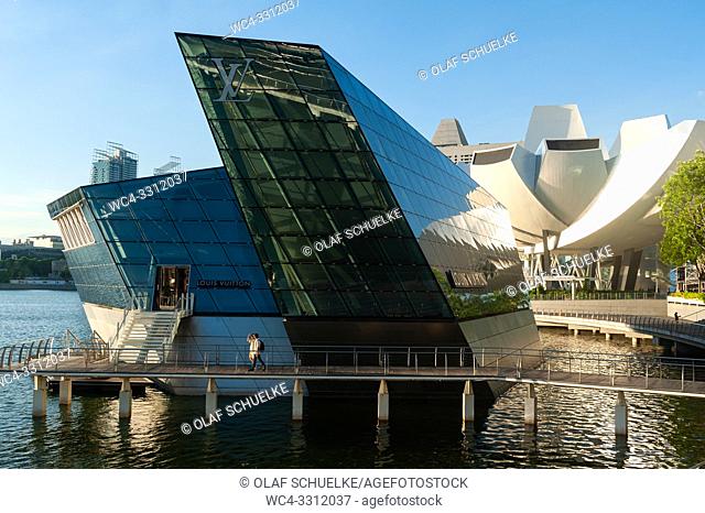 Singapore, Republic of Singapore, Asia - Louis Vuitton Island Maison luxury retail store at the Marina Bay Sands with the ArtScience Museum in the backdrop
