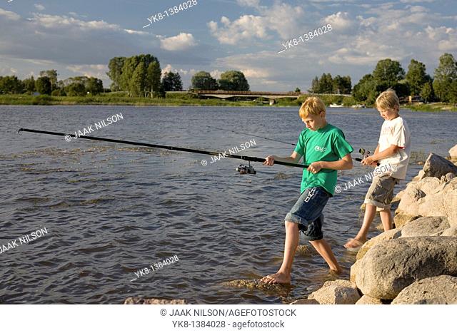 Two Teenage Boys Fishing on Pier by Lake Võrtsjärv in Estonia