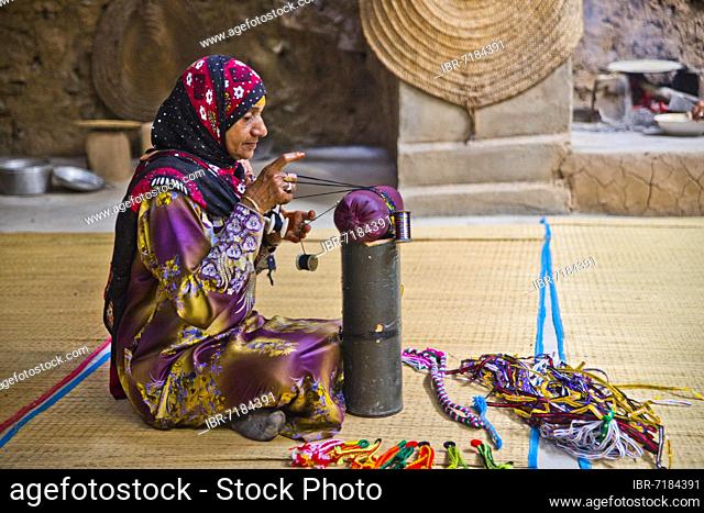 Woman making lace, traditional house, Bait al Safah museum of local history, old clay settlement of Al Hamra, Al Hamra, Oman, Asia
