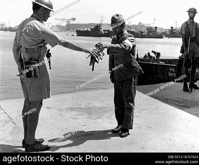 Token of Surrender -- A Japanese officer handling over the keys of the Yokosuka Naval Base to the Commander of the British landing force, Captain H.J