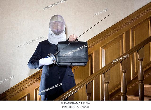 a business man in suit with a sword in his left in his hand, a briefcase in his right hand and a helmet on his head