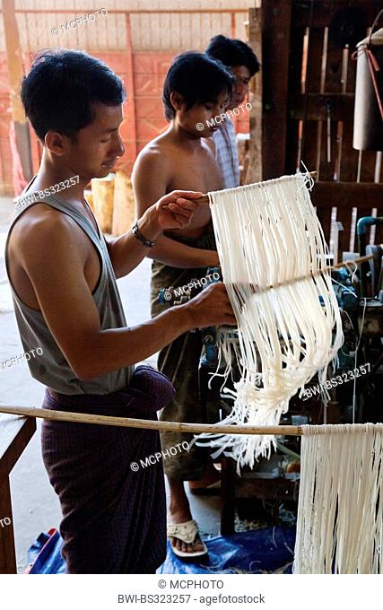young workers hanging up rice noodles on staves, Burma, Hsipaw
