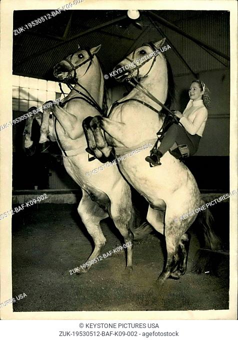 May 12, 1953 - Rehearsing for the Christmas Circus at Ascot.. Unique Spanish Horse Act.. Keystone Photo Shows: Miss Joan Fowles of Liverpool on right on...