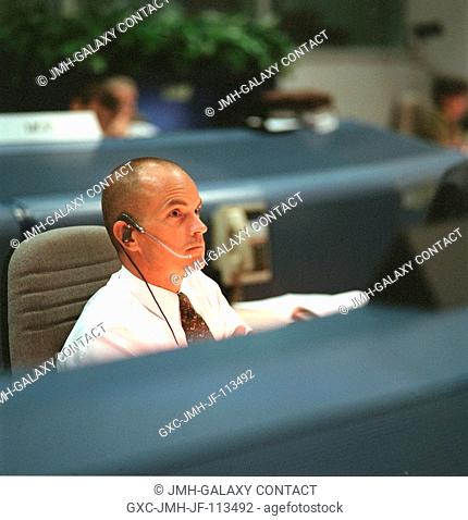Astronaut Frederick W. (Rick) Sturckow, seated at the spacecraft communicator (CAPCOM) console in JSC's Mission Control Center