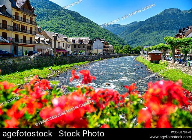 Garona river crossing the Pyrenean village of Bosost, located in the Aran Valley, Spain
