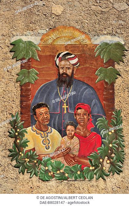 Saint Daniele Comboni with an African family, fresco on the outside wall of his historic house museum, Limone sul Garda, Lake Garda, Lombardy, Italy