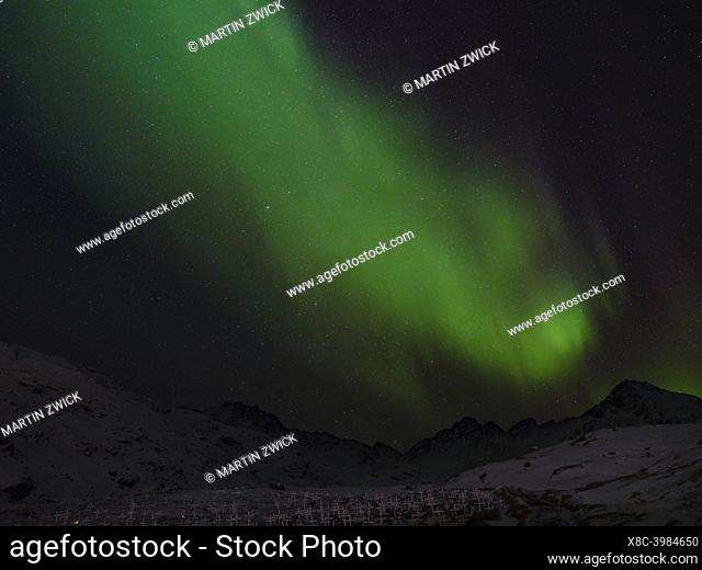 Northern Lights over the town. Town Tasiilaq (formerly called Ammassalik), the biggest town in East Greenland. America, Greenland, Tasiilaq, danish territory