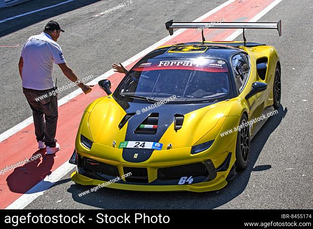 Racing car Sports car Ferrari 488 Challenge gets clearance from race marshal to exit pit lane onto circuit, FIA Formula One circuit
