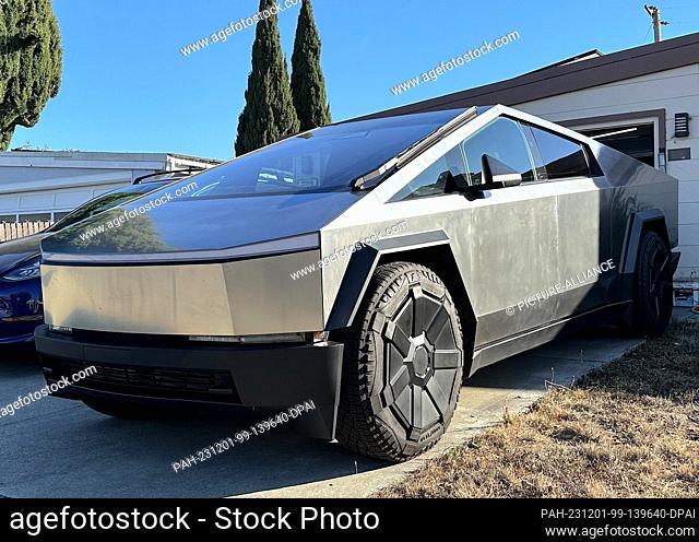 11 November 2023, USA, Santa Clara: A vehicle from Tesla's electric pickup ""Cybertruck"" series parked in front of a garage in Silicon Valley