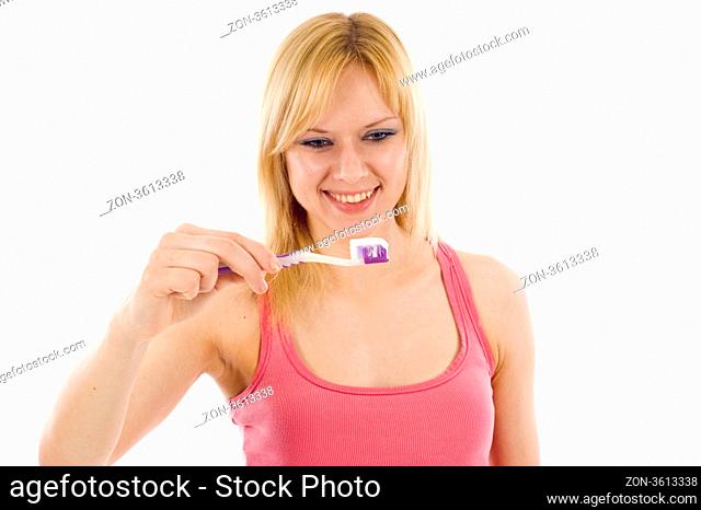 Smiling woman with a toothbrush isolated over white backgroundd
