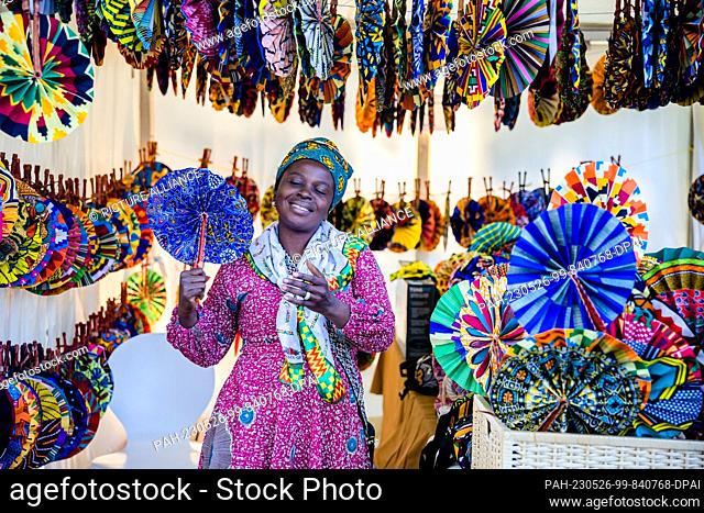 26 May 2023, Berlin: Angela holds a fan at her stand during the street festival on the first day of the Carnival of Cultures
