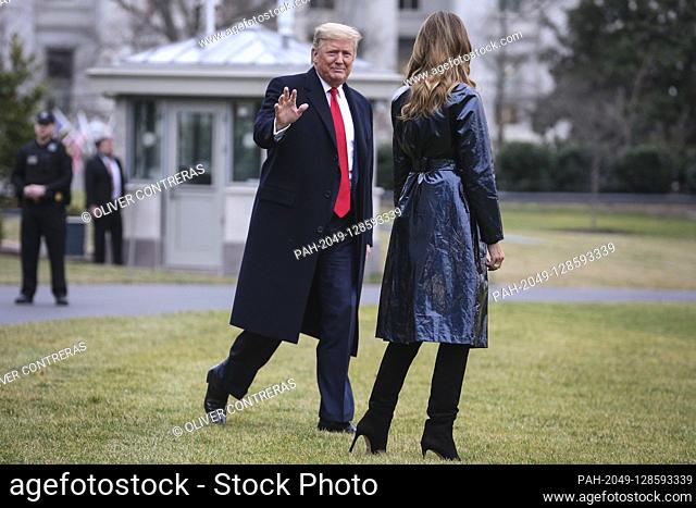 United States President Donald J. Trump waves to the media as he and first lady Melania Trump walk on the South Lawn of the White House before boarding Marine...